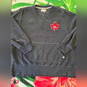 Canadiana pullover sweatshirt features a large red maple leaf patch.
